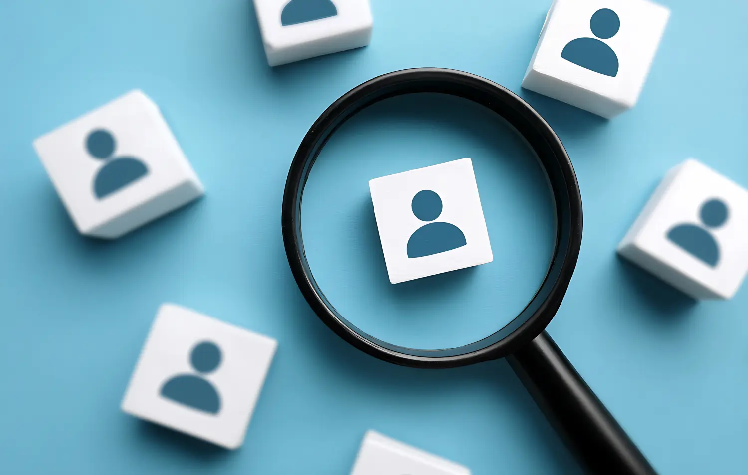 Den perfekten Kandidaten finden: Talentsuche, Personalbeschaffung, Lupe, Personensymbol, Würfel